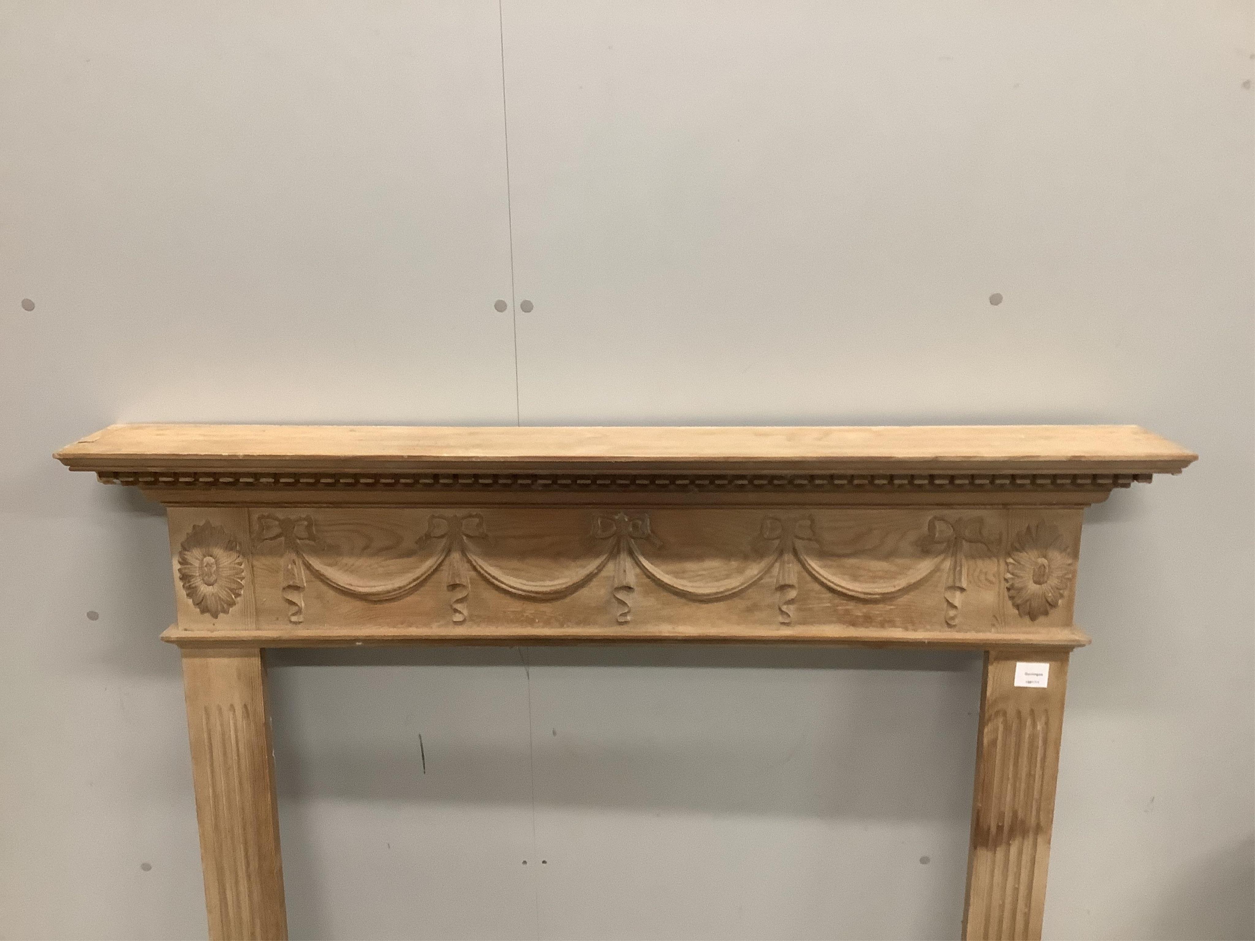 An Adam design pine fire surround, width 128cm, height 118cm. Condition - fair to good